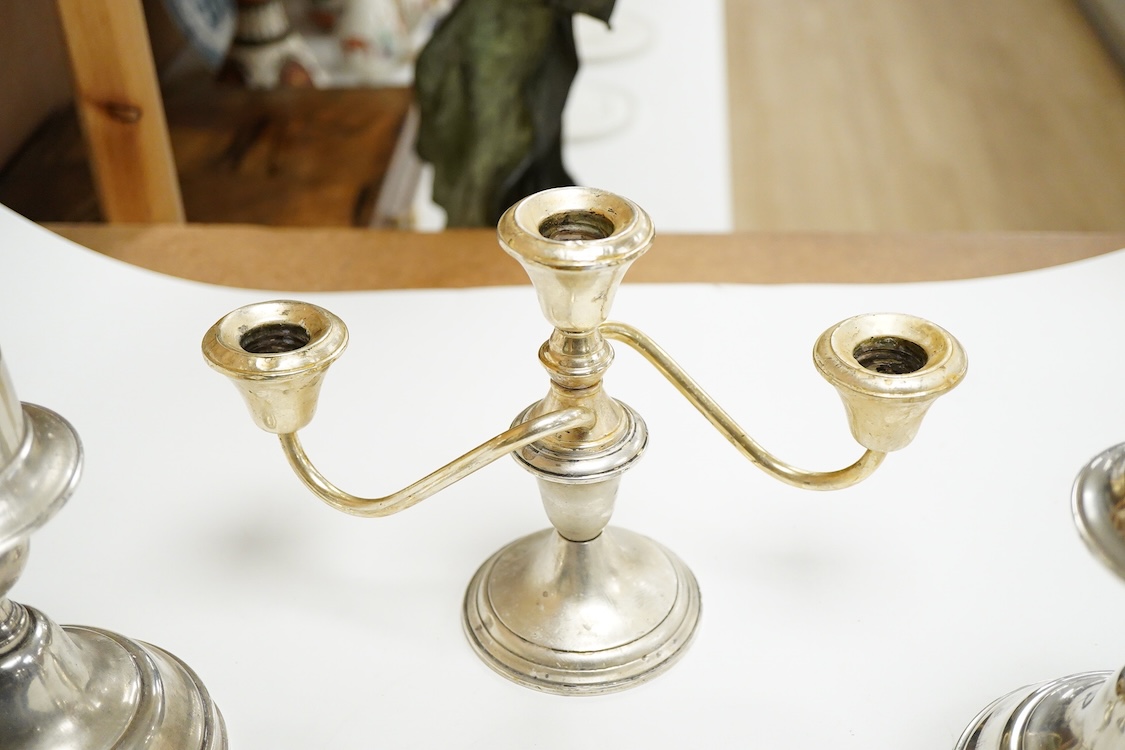 A pair of continental 800 standard white metal candlesticks, 15.5cm, 11.5oz, together with a Frank M. Whiting & Company sterling two branch, three light dwarf candelabrum, 15cm, weighted.
